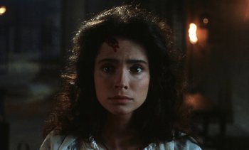 Movie still from “The Pit and the Pendulum” (1991), directed by Stuart Gordon – A woman with a blood splatter on her forehead; Close Up shot, Low angle