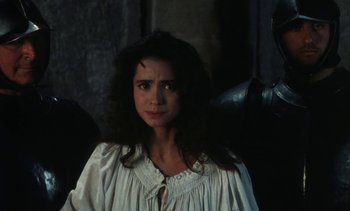 Movie still from “The Pit and the Pendulum” (1991), directed by Stuart Gordon – A woman wearing a white dress standing in front of a wall; Close Up shot, Over the shoulder angle