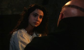 Movie still from “The Pit and the Pendulum” (1991), directed by Stuart Gordon – A woman in a white dress looking at a man in a black suit; Close Up shot, Over the shoulder angle