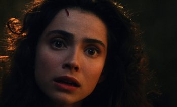 Movie still from “The Pit and the Pendulum” (1991), directed by Stuart Gordon – A person with a knife on her head; Close Up shot, Over the shoulder angle