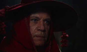 Movie still from “The Pit and the Pendulum” (1991), directed by Stuart Gordon – A person wearing a red hat; Close Up shot, Low angle