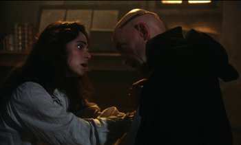 Movie still from “The Pit and the Pendulum” (1991), directed by Stuart Gordon – A man and a woman are looking at each other; Close Up shot, Over the shoulder angle