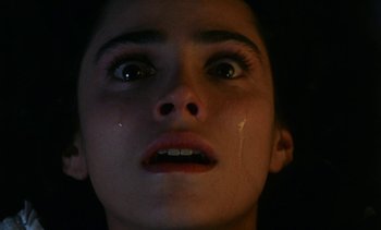 Movie still from “The Pit and the Pendulum” (1991), directed by Stuart Gordon – A person with a tear in their face; Extreme Close Up shot, Overhead angle