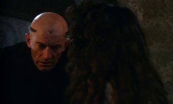 Movie still from “The Pit and the Pendulum” (1991), directed by Stuart Gordon – A man with a bald head looking into a mirror; Close Up shot, Over the shoulder angle