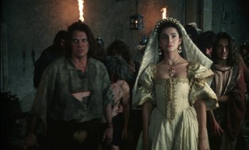 Movie still from “The Pit and the Pendulum” (1991), directed by Stuart Gordon – A man and a woman dressed in medieval garb; Medium shot, Over the shoulder angle