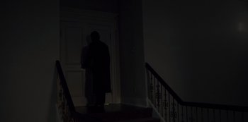 Movie still from “Fargo” (2014), created by Noah Hawley – A man standing on the stairs of a house; Wide shot, Low angle