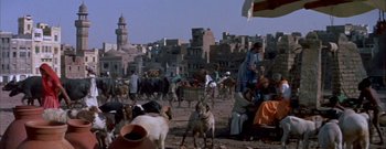 Movie still from “The Rains of Ranchipur” (1955), directed by Jean Negulesco – A group of people and animals in a city; Wide shot, High angle