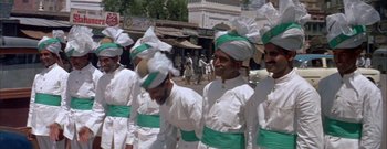 Movie still from “The Rains of Ranchipur” (1955), directed by Jean Negulesco – A group of men wearing white and green hats; Wide shot, High angle