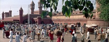 Movie still from “The Rains of Ranchipur” (1955), directed by Jean Negulesco – A crowd of people walking down a street; Extreme Wide shot, High angle