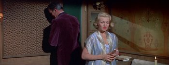 Movie still from “The Rains of Ranchipur” (1955), directed by Jean Negulesco – A man and a woman standing next to each other in a room; Medium shot, Over the shoulder angle