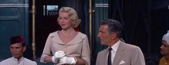 Movie still from “The Rains of Ranchipur” (1955), directed by Jean Negulesco – A man and a woman wearing white gloves; Medium shot, Low angle