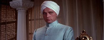 Movie still from “The Rains of Ranchipur” (1955), directed by Jean Negulesco – A person wearing a turban; Close Up shot, Low angle