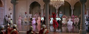 Movie still from “The Rains of Ranchipur” (1955), directed by Jean Negulesco – A group of people sitting and standing in a room; Wide shot, High angle