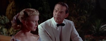 Movie still from “The Rains of Ranchipur” (1955), directed by Jean Negulesco – A man in a white suit sitting next to a woman in a white dress; Close Up shot, Low angle