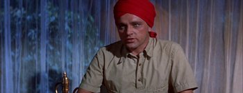 Movie still from “The Rains of Ranchipur” (1955), directed by Jean Negulesco – A man with a red turban on his head; Close Up shot, Low angle