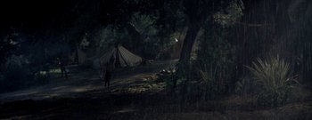 Movie still from “The Rains of Ranchipur” (1955), directed by Jean Negulesco – A group of people standing next to some tents; Extreme Wide shot, High angle