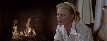 Movie still from “The Rains of Ranchipur” (1955), directed by Jean Negulesco – A woman in a white shirt and a yellow headband; Close Up shot, Over the shoulder angle