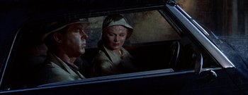 Movie still from “The Rains of Ranchipur” (1955), directed by Jean Negulesco – A man and a woman sitting in a car looking out the window; Close Up shot, High angle