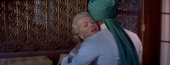 Movie still from “The Rains of Ranchipur” (1955), directed by Jean Negulesco – A woman is hugging another woman in a green dress; Medium shot, High angle