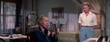 Movie still from “The Rains of Ranchipur” (1955), directed by Jean Negulesco – A woman is looking in the mirror in a bedroom; Close Up shot, High angle