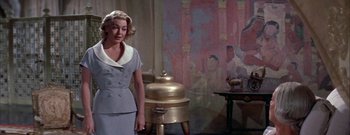 Movie still from “The Rains of Ranchipur” (1955), directed by Jean Negulesco – A woman standing in front of a painting; Medium shot, Low angle