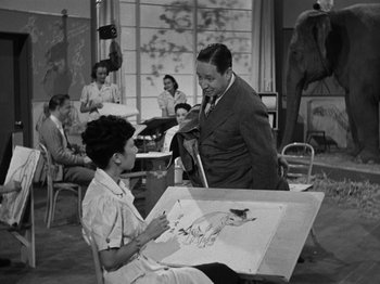 Movie still from “The Reluctant Dragon” (1941), directed by Jack Cutting – An old black and white photo of a man and a woman; Medium shot, Over the shoulder angle