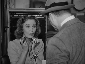 Movie still from “The Reluctant Dragon” (1941), directed by Jack Cutting – An old photo of a man and a woman looking at each other; Close Up shot, Over the shoulder angle