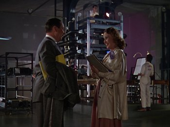 Movie still from “The Reluctant Dragon” (1941), directed by Jack Cutting – A man and a woman are talking to each other; Wide shot, Low angle