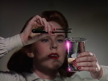 Movie still from “The Reluctant Dragon” (1941), directed by Jack Cutting – A woman holding a cell phone in front of her face; Close Up shot, Low angle