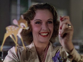 Movie still from “The Reluctant Dragon” (1941), directed by Jack Cutting – A woman smiles while holding a deer cookie cutter; Close Up shot, Low angle