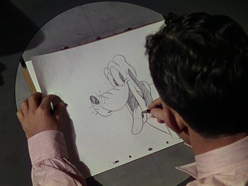 Movie still from “The Reluctant Dragon” (1941), directed by Jack Cutting – A man is drawing a goofy character on paper; Close Up shot, Over the shoulder angle