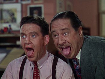 Movie still from “The Reluctant Dragon” (1941), directed by Jack Cutting – A couple of men standing next to each other; Close Up shot, Low angle