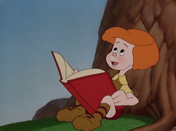Movie still from “The Reluctant Dragon” (1941), directed by Jack Cutting – A boy sitting on the ground reading a red book; Medium shot, Low angle