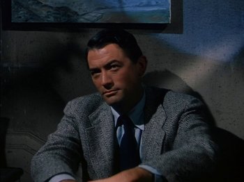 Movie still from “The Snows of Kilimanjaro” (1952), directed by Henry King – A person wearing a suit and tie; Medium shot, High angle