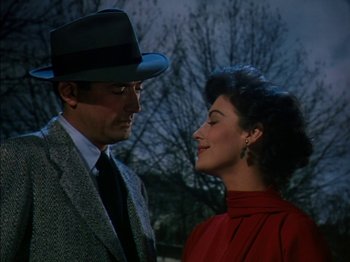 Movie still from “The Snows of Kilimanjaro” (1952), directed by Henry King – A man and a woman standing next to each other in front of trees; Close Up shot, Low angle