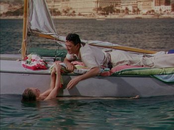 Movie still from “The Snows of Kilimanjaro” (1952), directed by Henry King – A man and a woman on a boat in the water; Wide shot, High angle