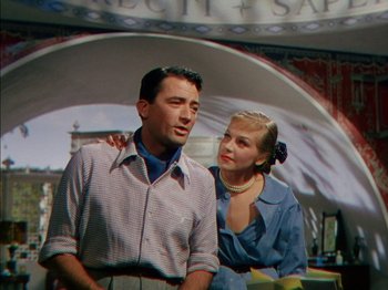 Movie still from “The Snows of Kilimanjaro” (1952), directed by Henry King – A man and a woman standing next to each other; Medium shot, Low angle