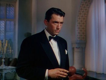 Movie still from “The Snows of Kilimanjaro” (1952), directed by Henry King – A person wearing a suit and tie; Medium shot, Low angle