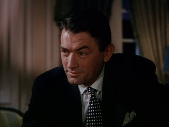 Movie still from “The Snows of Kilimanjaro” (1952), directed by Henry King – A person wearing a suit and tie; Close Up shot, High angle