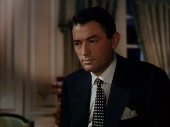 Movie still from “The Snows of Kilimanjaro” (1952), directed by Henry King – A person wearing a suit and tie; Close Up shot, High angle