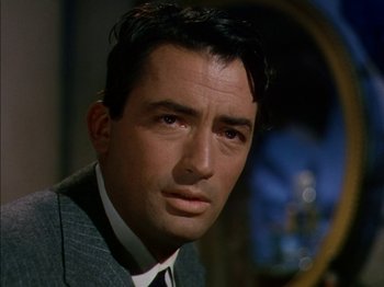 Movie still from “The Snows of Kilimanjaro” (1952), directed by Henry King – A person wearing a suit and tie; Close Up shot, Over the shoulder angle