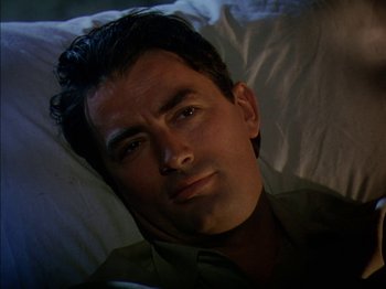 Movie still from “The Snows of Kilimanjaro” (1952), directed by Henry King – A person laying in a bed; Close Up shot, High angle