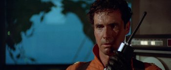 Movie still from “The Swarm” (1978), directed by Irwin Allen – A person wearing an orange shirt; Close Up shot, Low angle