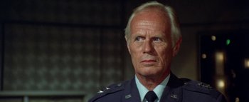 Movie still from “The Swarm” (1978), directed by Irwin Allen – An older man wearing a uniform looking to his left; Close Up shot, Low angle