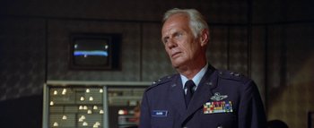 Movie still from “The Swarm” (1978), directed by Irwin Allen – An older man in a military uniform looking to his left; Close Up shot, Low angle