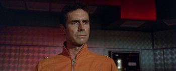 Movie still from “The Swarm” (1978), directed by Irwin Allen – A person wearing an orange jacket; Close Up shot, Low angle