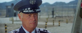 Movie still from “The Swarm” (1978), directed by Irwin Allen – An older man in a uniform is looking at the camera; Close Up shot, Low angle