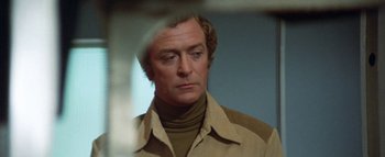 Movie still from “The Swarm” (1978), directed by Irwin Allen – A person wearing a jacket; Close Up shot, Over the shoulder angle