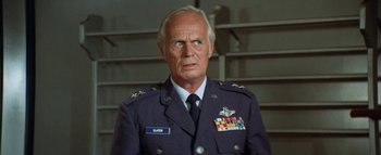 Movie still from “The Swarm” (1978), directed by Irwin Allen – An older man in a military uniform looking at the camera; Close Up shot, Low angle