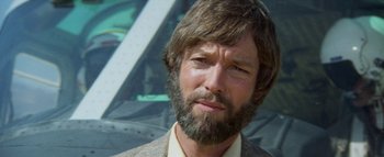 Movie still from “The Swarm” (1978), directed by Irwin Allen – A person wearing a suit and beard; Close Up shot, Low angle